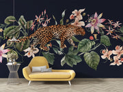 Exotic Leopard Wall Mural featuring a detailed leopard walking through lush tropical flowers and leaves on a dark background.