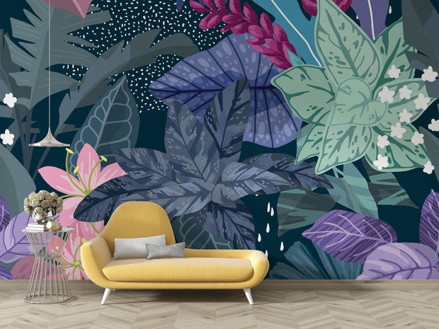 Illustrated tropical botanical wall mural with large jungle leaves, pink lilies, white flowers, and deep blue background, styled in a modern living room.