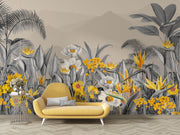 Modern tropical botanical wall mural with grayscale jungle leaves, vibrant yellow flowers, and a misty mountain backdrop in a cozy bedroom setting.