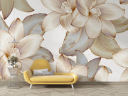 Golden floral wall mural with intricate oversized flowers and leaves in a modern living room with yellow sofa.
