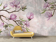 Pink Magnolia Wall Mural with blooming branches on a textured background in a modern living room with yellow sofa.