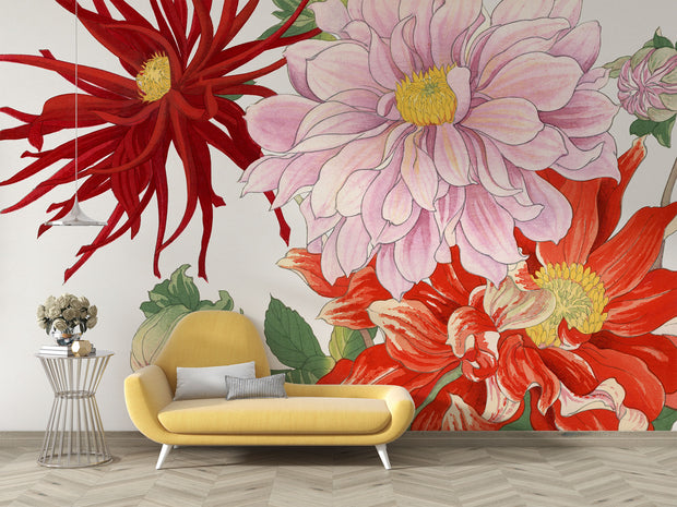 Oversized floral wall mural featuring red, pink, and yellow illustrated blooms with green leaves behind a yellow modern sofa.