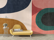 Earthy geometric wall mural with abstract curved shapes in green, ochre, navy, and blush, creating a modern and minimalist bedroom atmosphere.
