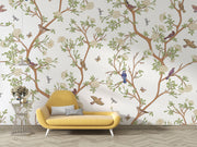 Nature-inspired floral and bird wall mural featuring blooming flowers, branches, birds, and butterflies in a living room setting.