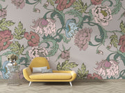 Garden bloom wall mural with pastel pink, green, and blue peonies and leaves, styled in a living room with yellow sofa.
