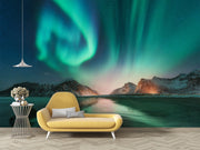 Northern lights wall mural featuring green and blue auroras over snowy mountains and a frozen lake, creating a mesmerizing and tranquil atmosphere.