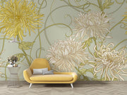 Art Nouveau floral wall mural with intricate yellow and beige chrysanthemum flowers on a sage-green background, styled in a modern living space.