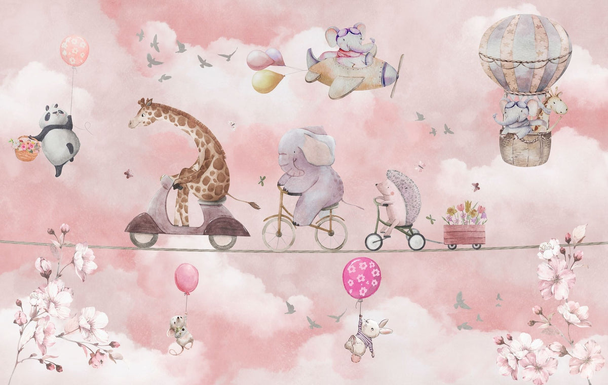 A whimsical nursery wall mural featuring playful animals, including a giraffe on a scooter, an elephant on a bike, and a panda floating with balloons over pink clouds.