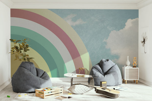 Modern playroom with retro pastel rainbow wall mural and sky backdrop, styled with bean bags and guitar.