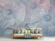 Ethereal large-scale poppy wall mural in soft blues and pinks, styled in a modern minimalist living room with a sofa.