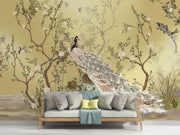 Golden Bloom wall mural with a cream peacock, flowering tree branches, and birds on a golden background in an elegant, Chinoiserie-style interior.