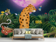 Midnight Safari wall mural with a whimsical leopard in a vibrant jungle, surrounded by butterflies and a glowing purple moon, styled in a living room.