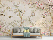 Elegant bedroom interior featuring a pastel Chinoiserie wall mural with delicate cherry blossoms and birds, decorating a living room with sofa.