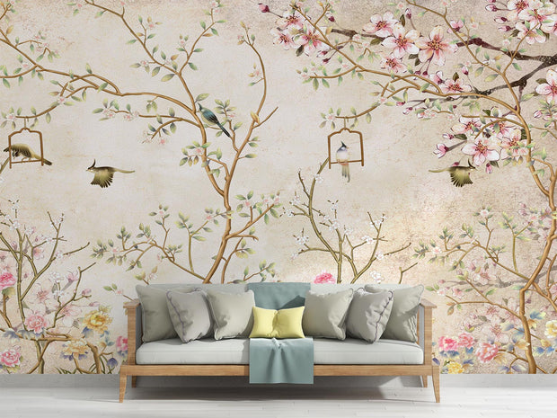 Elegant bedroom interior featuring a pastel Chinoiserie wall mural with delicate cherry blossoms and birds, decorating a living room with sofa.
