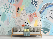 Playful abstract wall mural with colorful brushstrokes, dotted patterns, and modern art elements in a living room setting.