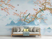 Chinoiserie-style wall mural featuring cherry blossom branches, perched birds, and misty blue mountains, creating a serene and elegant atmosphere.