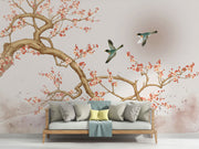Chinoiserie-style wall mural featuring blooming cherry blossoms, elegant birds in flight, and a soft watercolor-inspired background with a subtle sun.