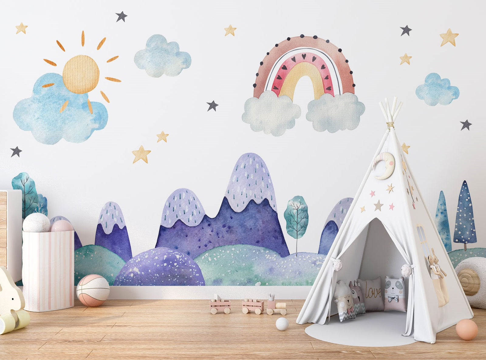 Watercolor kids' room mural with pastel mountains, a rainbow, a sun, clouds, and stars for a dreamy, playful atmosphere.