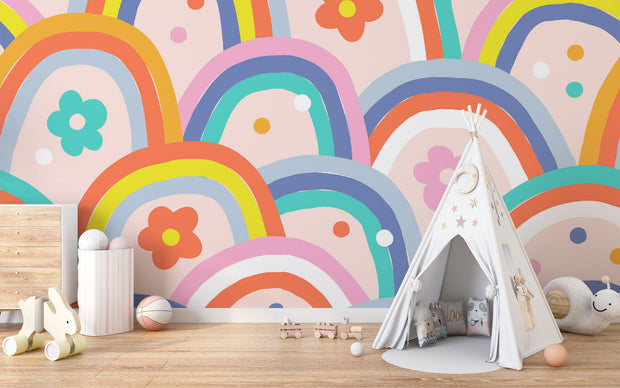 Kids wall mural with retro-style rainbow arches and colorful flowers in a playful, children's playroom.