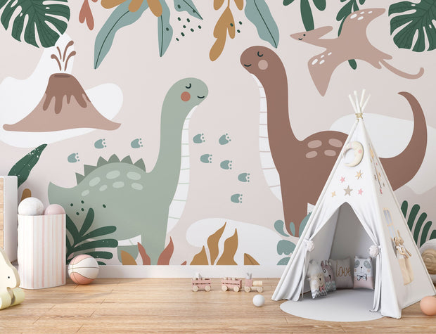Kids’ wall mural with cartoon dinosaurs, volcano, pterodactyl, and tropical leaves in soft earth tones; styled in a cozy children’s playroom.