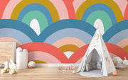 Colorful retro rainbow mural in a kids playroom with teepee tent, pastel toys, and playful decor.