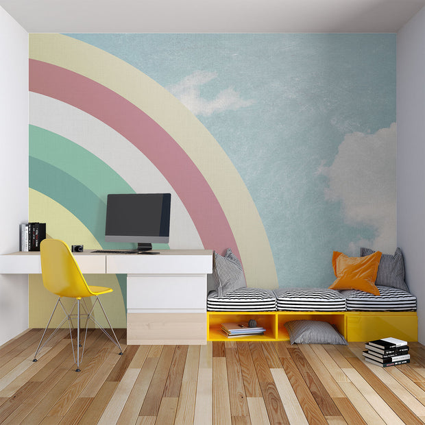 Modern bedroom with retro pastel rainbow wall mural and sky backdrop, styled with minimalist white furniture.