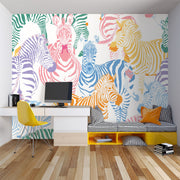 Multicolor zebra wall mural featuring vibrant pink, blue, orange, and yellow zebras on a white background, ideal for modern decor.