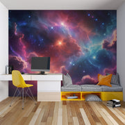 Celestial nebula wall mural featuring vibrant clouds of cosmic gas in blues, purples, and reds with glowing stars, styled in a modern bedroom.