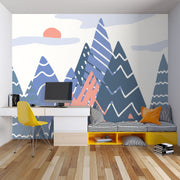 Adventure Peaks wall mural featuring abstract mountain shapes in blue and peach tones with a sun and clouds, styled in a boy’s bedroom.