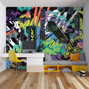 Colorful gaming-themed wall mural in a room with a desk and chair.