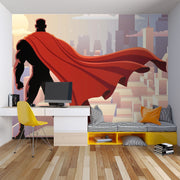 Wall mural depicting a superhero in a red cape looks over the city.