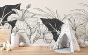 Minimalist playroom with wood flooring, teepee tent, and elegant black and white flower wall mural.