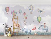 Safari-themed wall mural with watercolor animals, hot air balloons, and a pastel sky—ideal for nursery and kids' room décor.