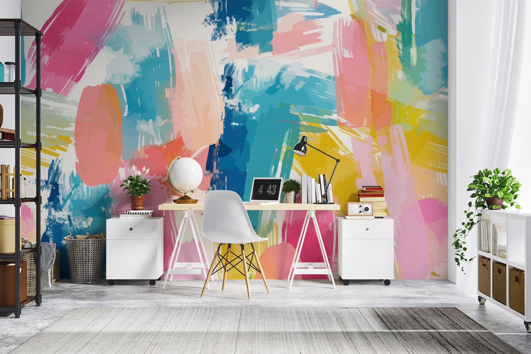 Colorful abstract wall mural with brushstroke patterns in vibrant pink, blue, yellow, and coral shades, installed behind a modern home office setup.