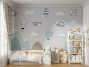 Aviation-themed wall mural for kids featuring airplanes, helicopters, hot air balloons, and mountains in soft pastel colors, perfect for a nursery or playroom.