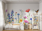 Watercolor wildflower wall mural featuring hand-painted flowers in vibrant colors with butterflies, styled in a playful children’s room with a white teepee.