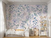 Delicate pastel floral wall mural with soft lavender, blush pink, and green botanical patterns in a girls' bedroom.