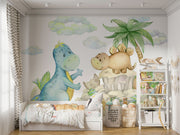 Cute dinosaur wall mural with watercolor-style dinosaurs, tropical plants, and soft pastel clouds, perfect for nurseries, kids' bedrooms, and playrooms.