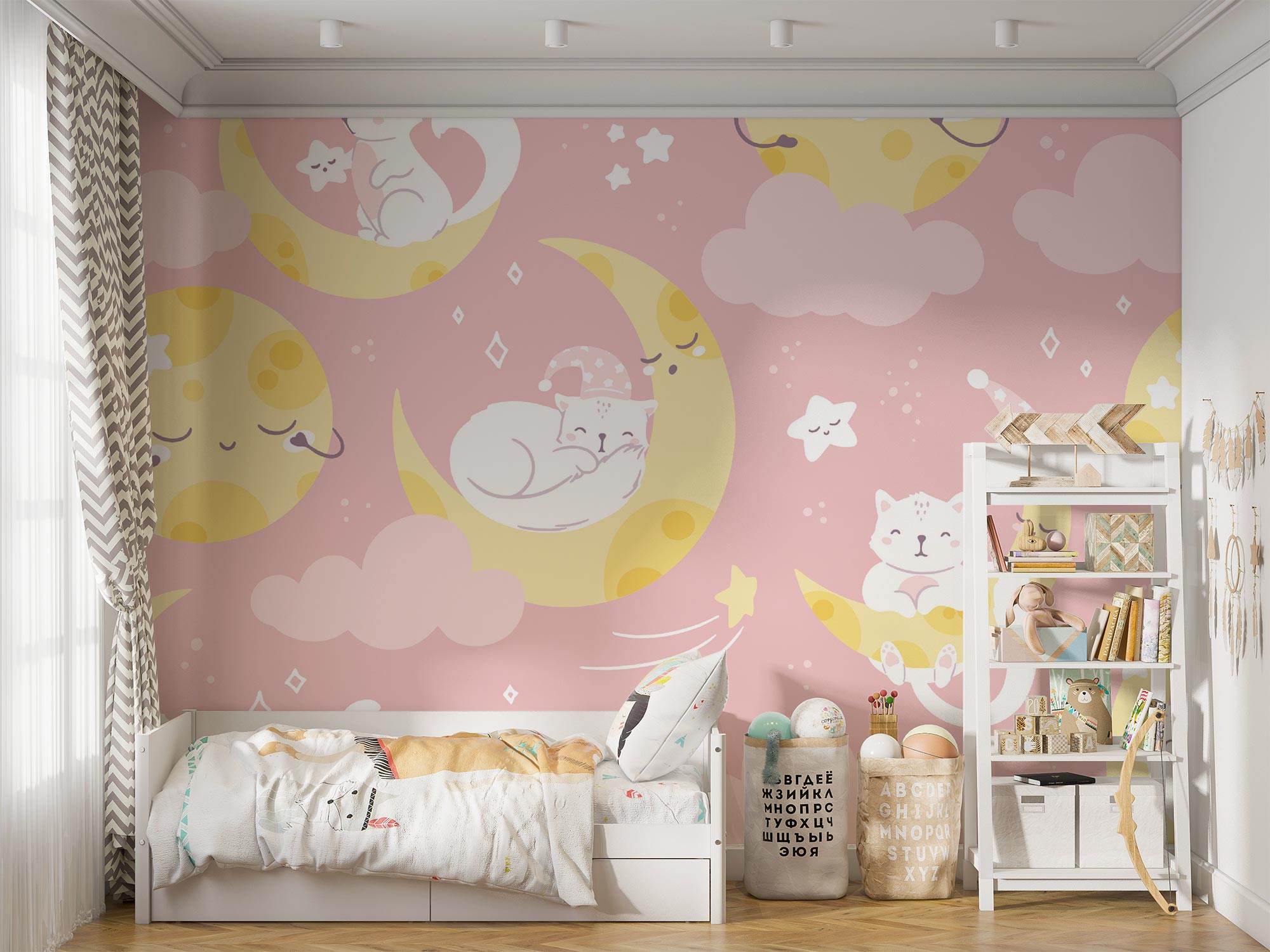 Moon-and-cat-themed wall mural featuring pastel pink tones, crescent moons, sleepy cats and stars, decorating a cozy nursery with soft bedding, toys, and storage shelves.