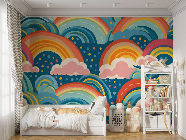 Bold and colorful rainbow wall mural with pink clouds and blue background, decorating kids playroom.