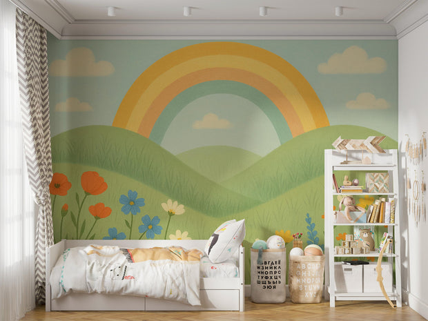 Rainbow mural decorating a toddler bedroom with cozy bed, bookshelf, and toys.