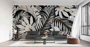 Black and white tropical leaf wall mural with gold accents, featuring monstera and palm leaves in a modern botanical design.