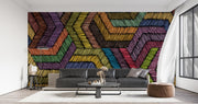 Modern rainbow geometric wall mural with textured chevron pattern, styled in modern living room with black leather sofa.