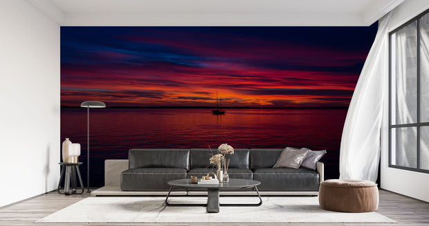 Sunset Over the Ocean Wall Mural – Stunning Seascape Wallpaper Featuring a Sailboat Silhouette, Deep Twilight Sky, and Serene Ocean Waters for Relaxing Interiors.