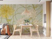 Art Nouveau floral wall mural with intricate yellow and beige chrysanthemum flowers on a sage-green background, styled in a cozy dining space.