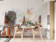 Watercolor Paris mural featuring the Eiffel Tower with pastel skies and ink sketch trees in a cosy living room setting.