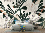 Lush foliage wall mural with bold green, beige, and rust botanical patterns and abstract dotted accents.