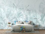 Soft blue palm leaf wall mural featuring oversized banana leaves on a light pastel background, perfect for modern interiors.