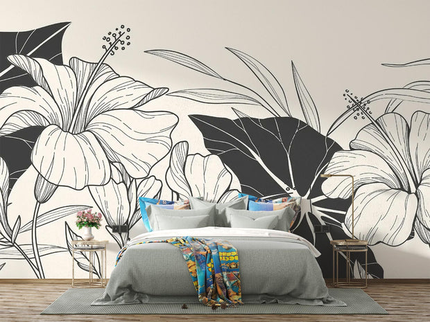 Sophisticated bedroom with gray bedding and a black and white floral mural as a statement wall.