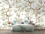 Nature-inspired floral and bird wall mural featuring blooming flowers, branches, birds, and butterflies in a living room setting.